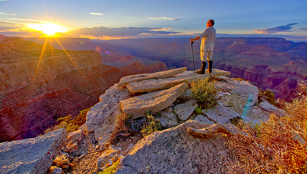 A hiker watching the sun go down west of Moran Point at Grand Canyon, Grand Canyon National Park, UNESCO World Heritage Site, Arizona, United States of America, North America