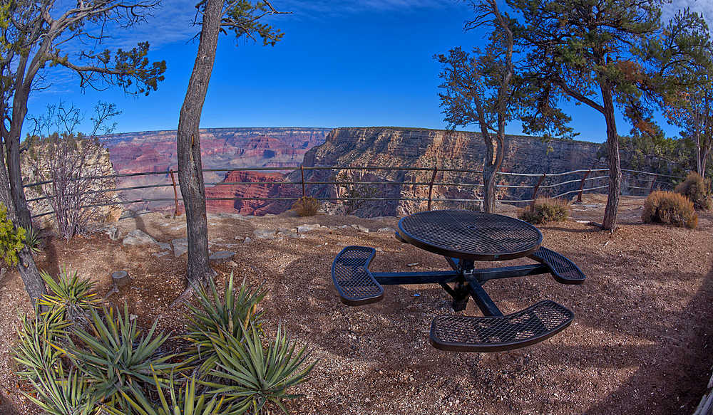 Steel picnic table along the rim trail overlooking Grand Canyon South Rim off Hermit Road halfway between Monument Creek Vista and The Abyss, Grand Canyon, Arizona, United States of America, North America