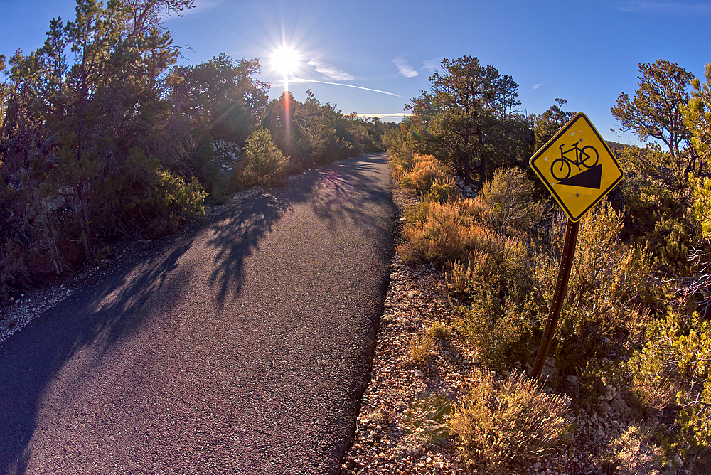 The paved Greenway trail west of Monument Creek Vista with a sign warning cyclists of a steep gradient ahead, Grand Canyon, Arizona, United States of America, North America