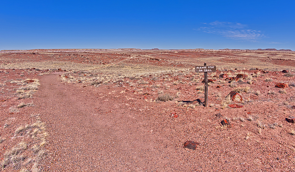 A warning sign to stay on the trail to the historic Agate House in Petrified Forest National Park, Arizona, United States of America, North America