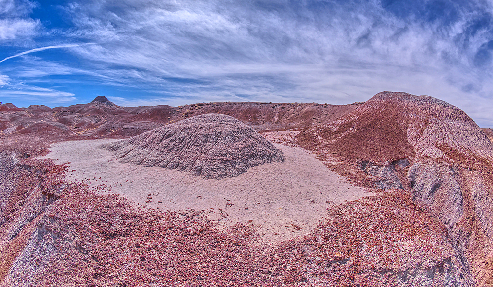 A small hill of gray bentonite clay that appears to be melting into the purple bentonite of Hamilili Valley on the south end of Petrified Forest National Park, Arizona, United States of America, North America