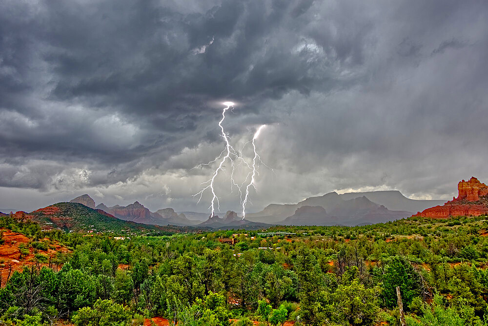 Lightning striking during a storm over Cibola Rock in Uptown, viewed from the Broken Arrow Trail, Sedona, Arizona, United States of America, North America