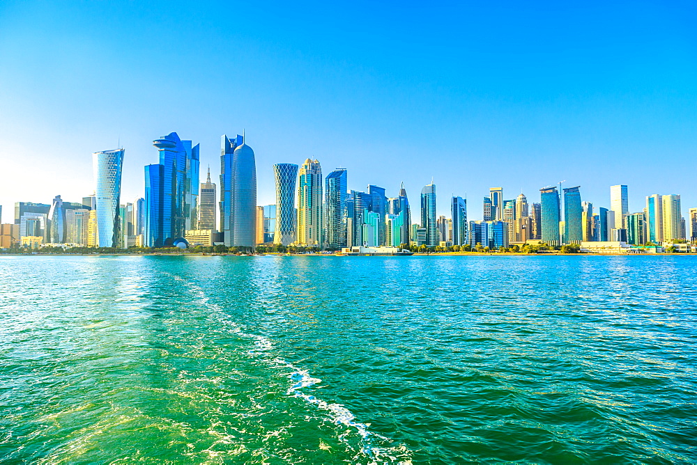 Cityscape of Doha West Bay skyline from boat trip in Doha Bay at sunset light, Doha, Qatar, Middle East