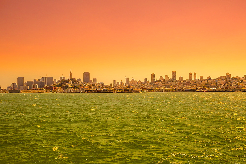 Sea view from boat to Alcatraz at sunset of San Francisco Financial District skyline, San Francisco, California, United States of America, North America