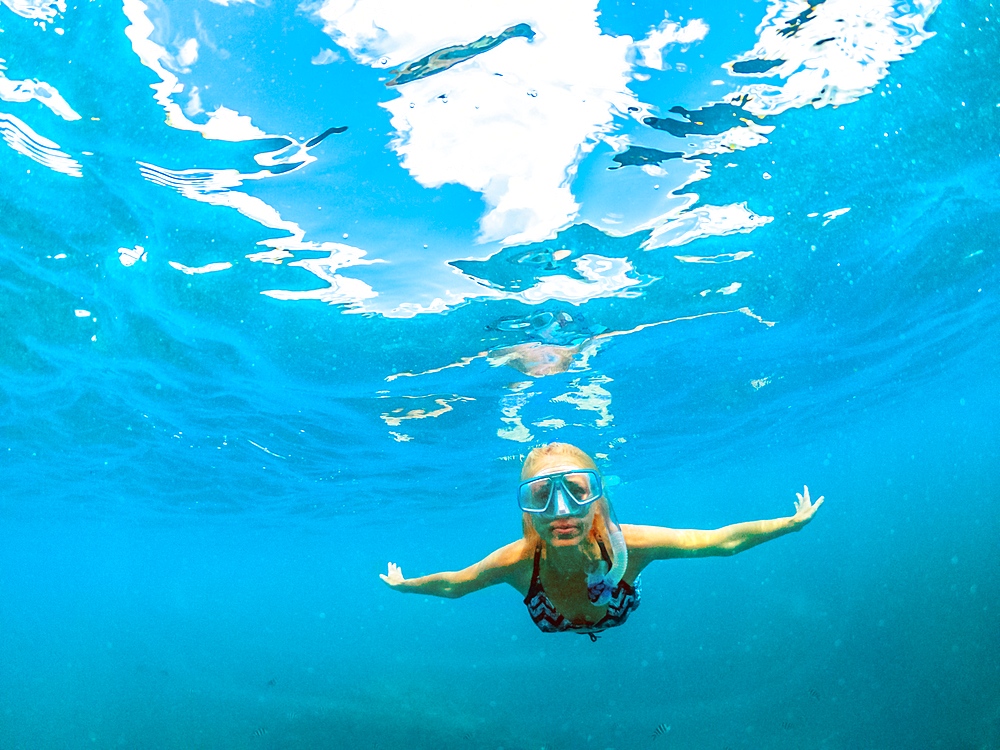 Female in bikini swimming underwater, Seychelles, Indian Ocean, Africa