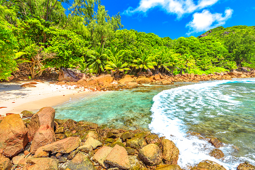 Remote Caiman Beach between Anse Fourmis and Anse Cocos protected by huge rock formations, La Digue, Seychelles, Indian Ocean, Africa