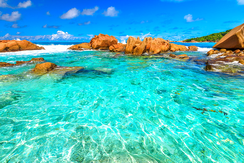 Turquoise sea of natural pool, clear calm waters of swimming pools at Anse Cocos near Grand Anse and Petite Anse protected by rock formations, La Digue, Seychelles, Indian Ocean, Africa