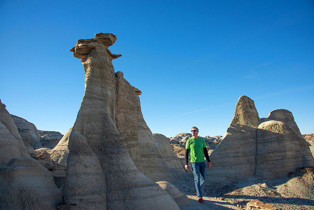 Hiking around hoodoo sandstone formations in Bisti/De-Na-Zin Wilderness, New Mexico, United States of America, North America