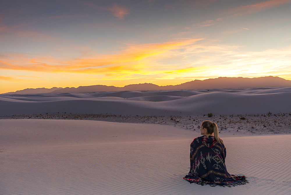 Woman watching the sunset in White Sands National Park, New Mexico, United States of America, North America