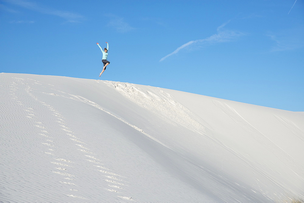 Jumping off a sand dune in White Sands National Park, New Mexico, United States of America, North America