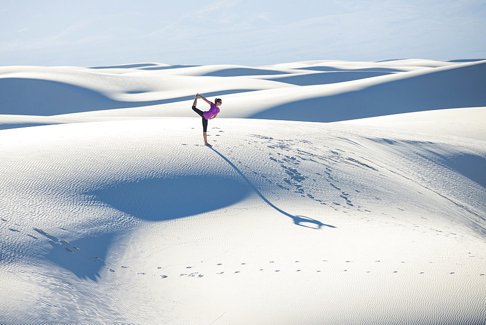 Stretching with a yoga pose in White Sands National Park, New Mexico, United States of America, North America