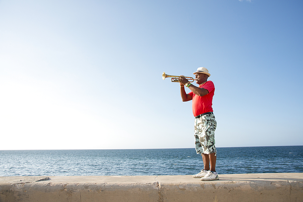 Trumpet player along the Malecon in Havana, Cuba, West Indies, Caribbean, Central America