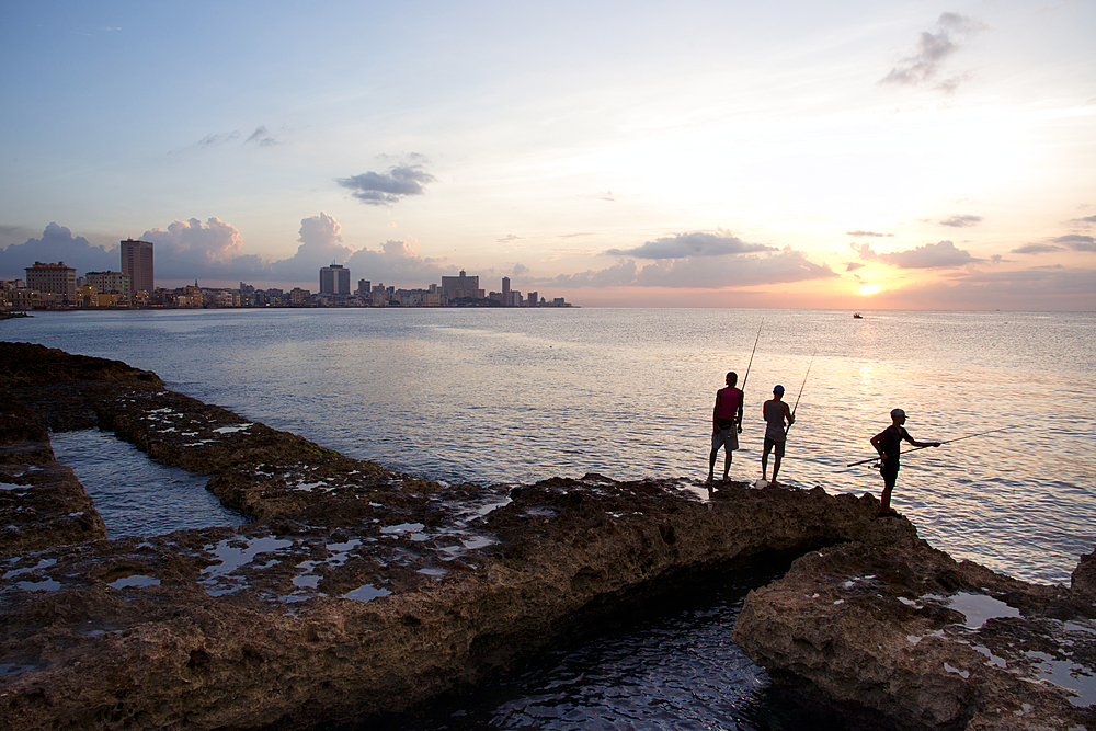 Fishing along the Malecon at sunset in Havana, Cuba, West Indies, Caribbean, Central America