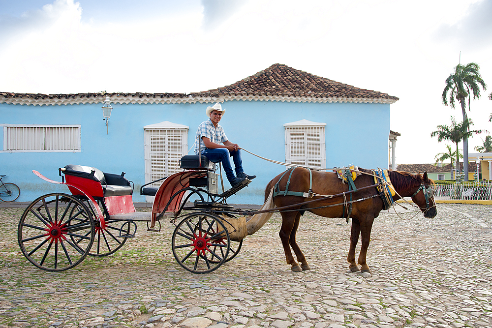 Cowboy waiting for riders with his horse and carriage in Plaza Mayor, Trinidad, UNESCO World Heritage Site, Cuba, West Indies, Caribbean, Central America