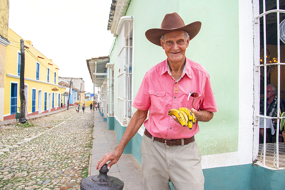 Man selling bananas on a street corner in Trinidad, Cuba, West Indies, Caribbean, Central America