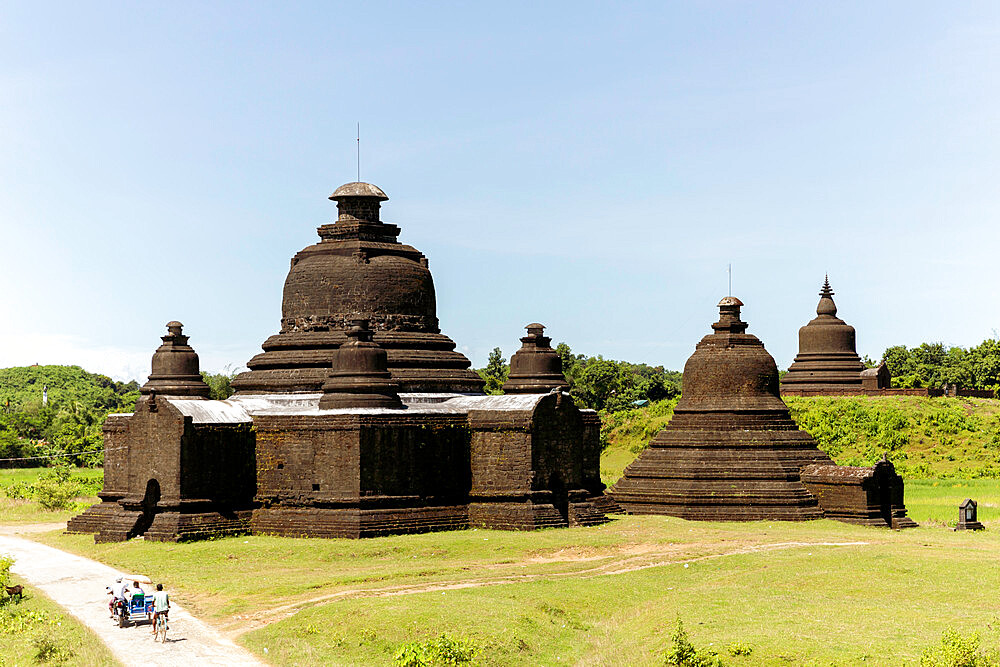 Lay Myet Hna Temple, with figures on a bicycle and motorbike on the road to the side, Mrauk U, Rakhine, Myanmar (Burma), Asia