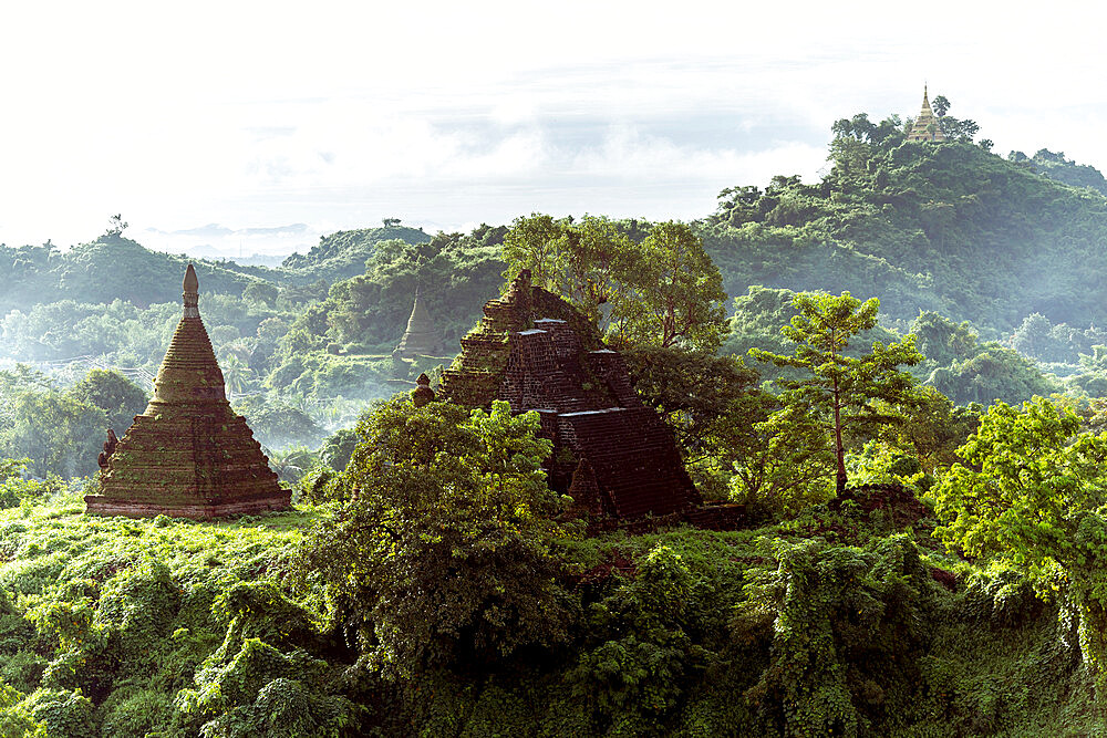 The view from Shin Mra War Pagoda, showing small stupas on small jungle covered hills with mountain ridges in the background, Mrauk U, Rakhine, Myanmar (Burma), Asia