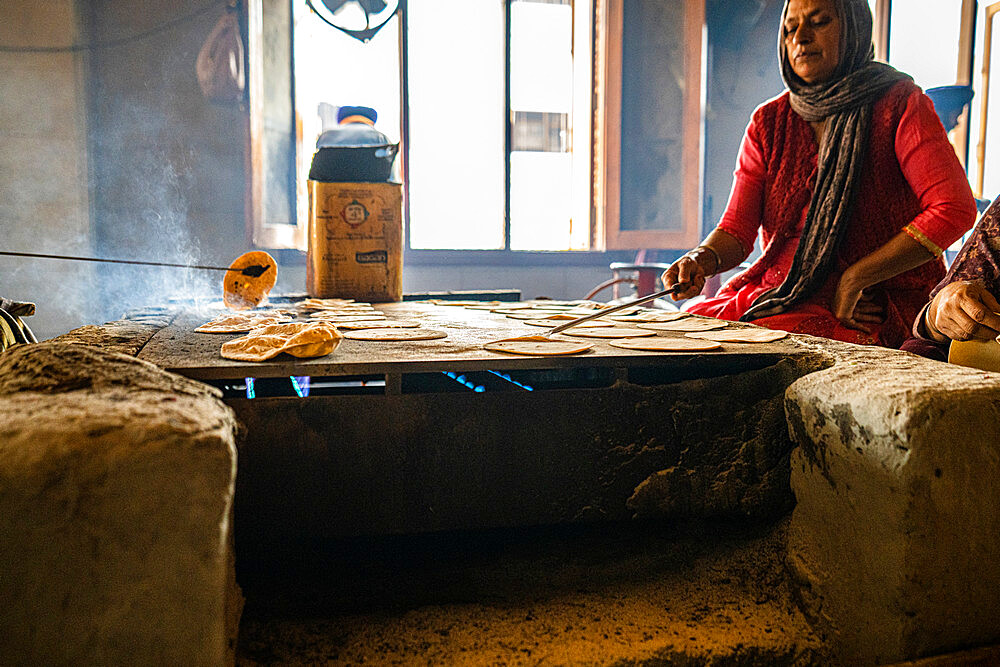 Fresh Roti being handmade on a flatop grill inside the Golden Temple, Amritsar, Punjab, India, Asia