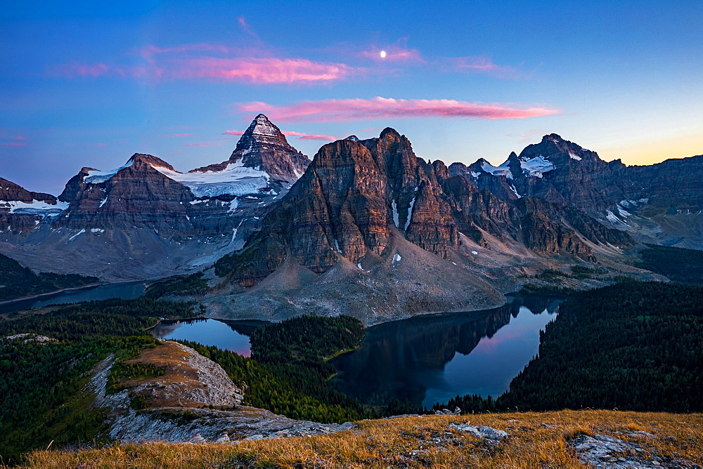 Sunset on top of Nub Peak, looking at Mount Assiniboine and the moon, Mount Assiniboine rises nearly 1525m above Lake Magog, Alberta, Canadian Rockies, Canada, North America