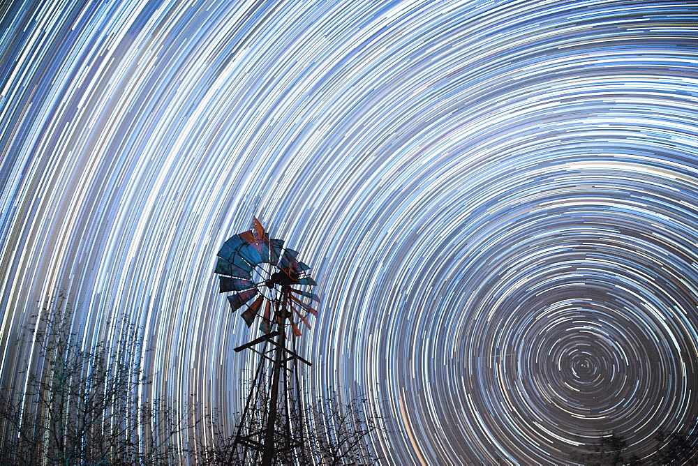 Startrail with windmill in foreground, Timbavati, South Africa, Africa