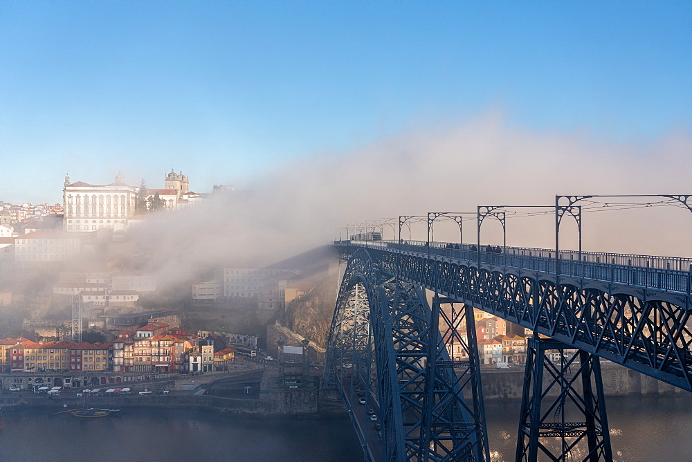 Dom Luis I Bridge with tram and view of Porto in the early morning mist, Porto, Portugal, Europe