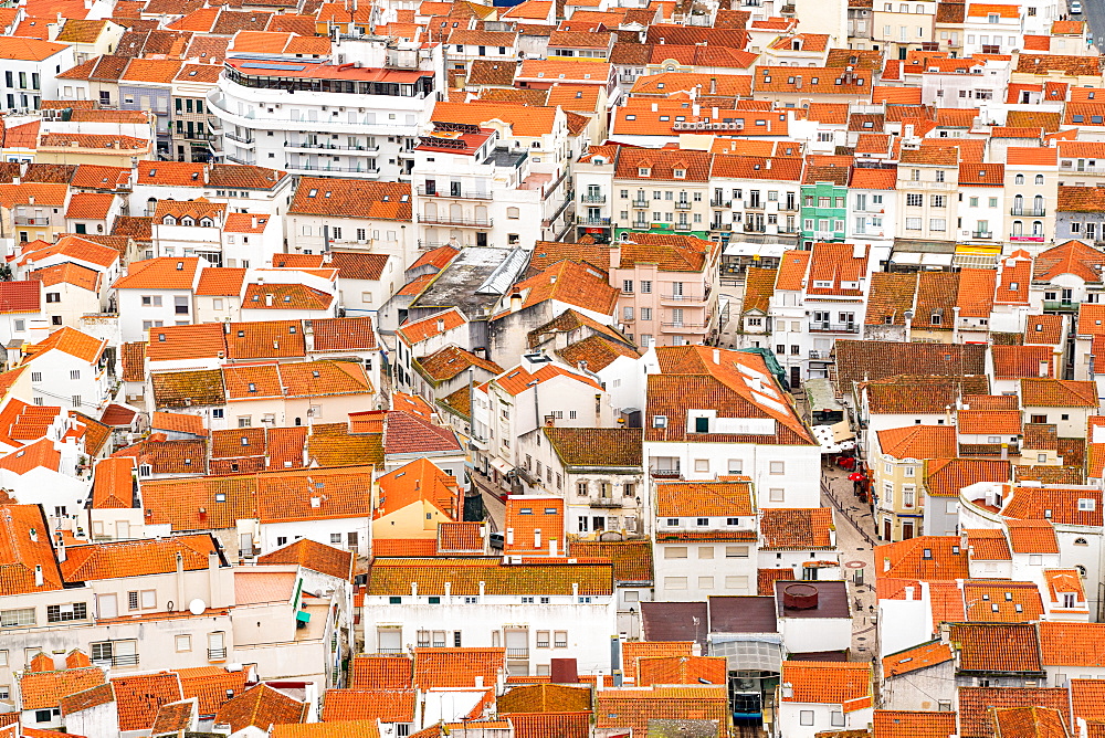 Looking down to orange tiled rooftops in the town of Nazare, Estremadura, Portugal, Europe