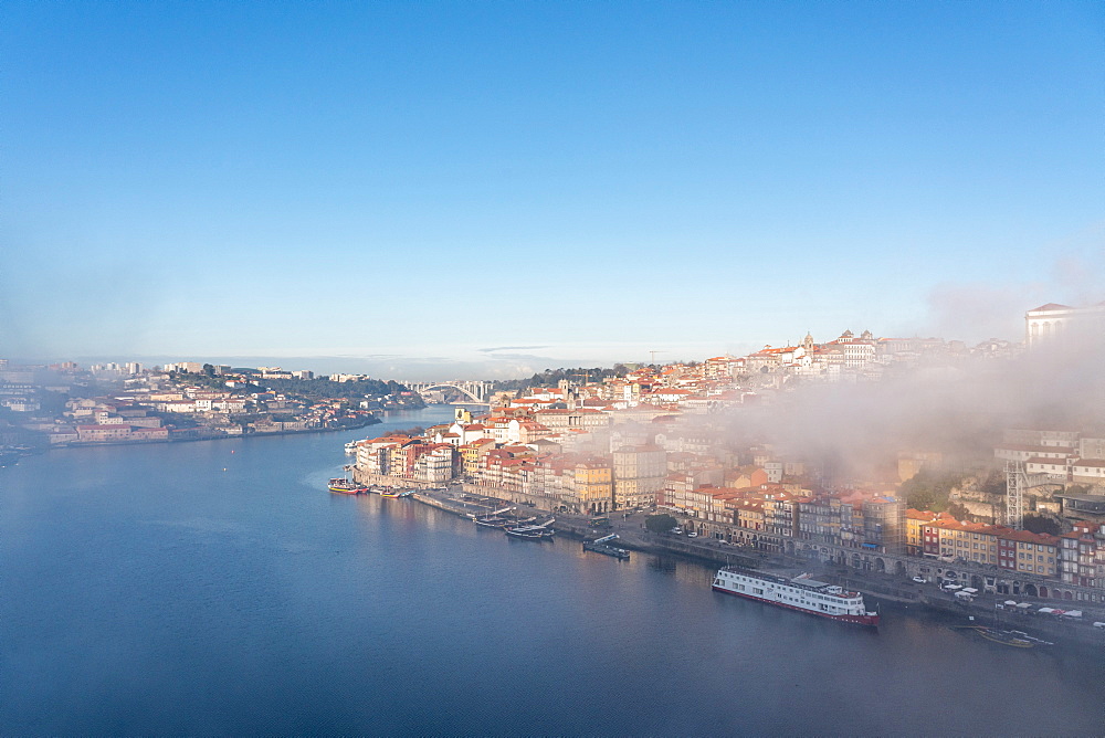 View of Porto in the early morning mist from Dom Luis I Bridge looking down to the River Douro, Porto, Portugal, Europe