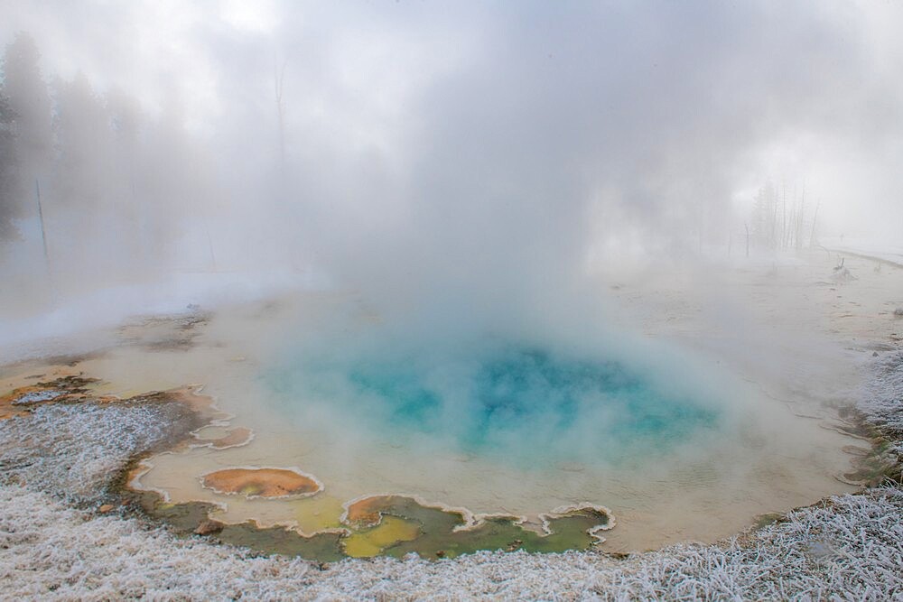 Blue thermal feature in the fog and snow, Yellowstone National Park, UNESCO World Heritage Site, Wyoming, United States of America, North America