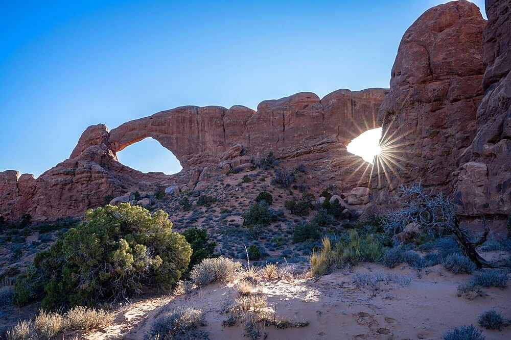 Sunburst through Windows Arch, Arches National Park, Utah, United States of America, North America