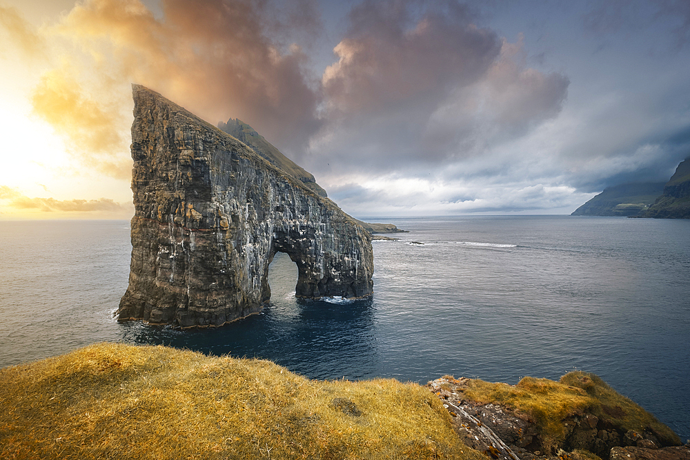 Sunset at Drangarnir, the famous sea stack in Vagar island, Faroe Islands, Denmark, North Atlantic, Europe