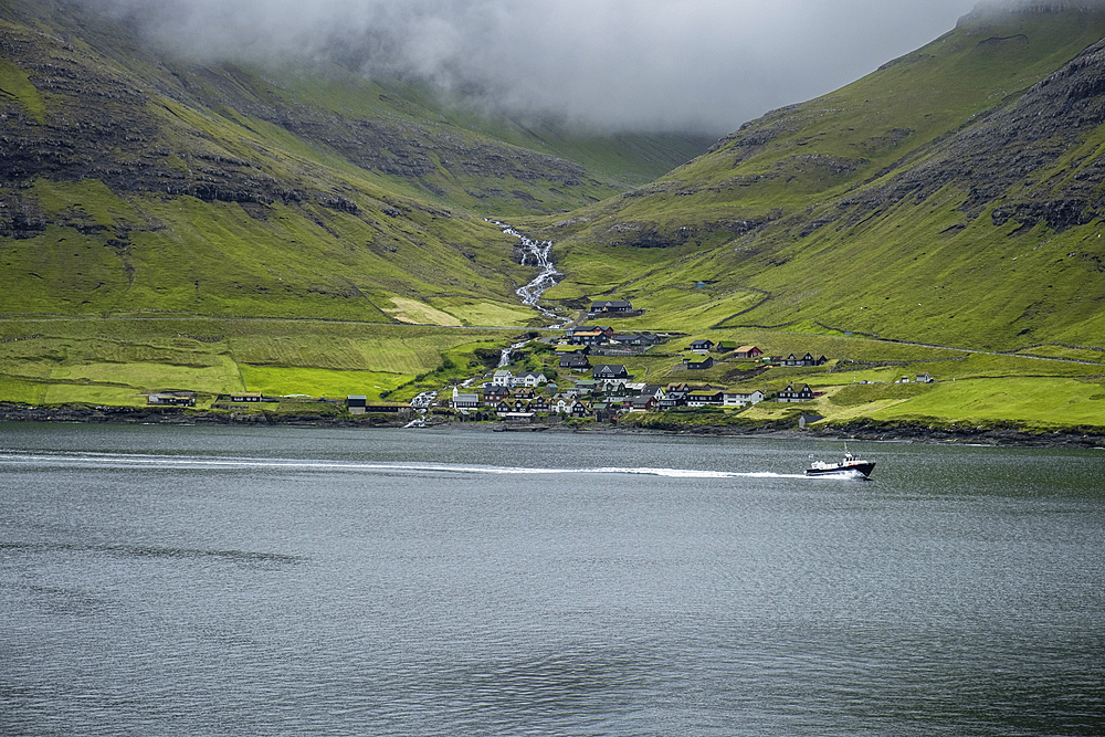 A small village nestled in the green mountains of the Faroe islands, Denmark, Atlantic, Europe