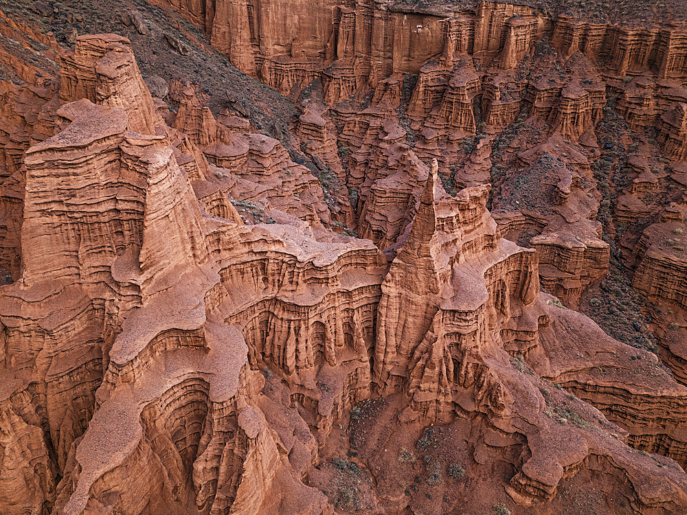 Drone view of Kok-Moinok Canyon, a clay-sand structure formed on the slopes of arid mountains cut by water streams, Kyrgyzstan, Central Asia, Asia