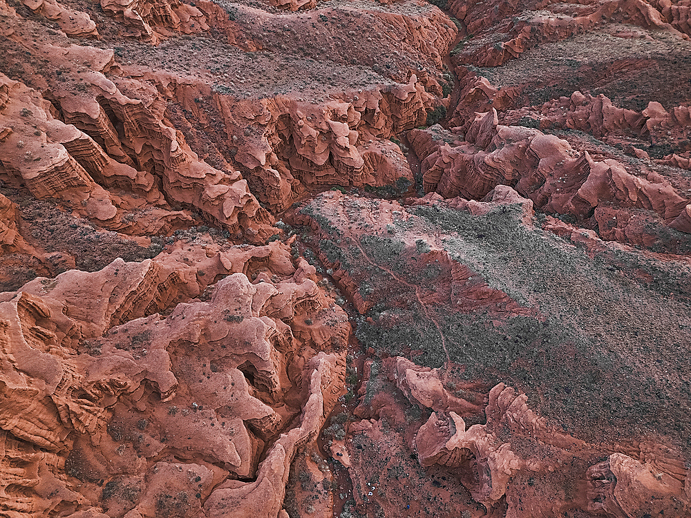 Aerial view of Kok-Moinok Canyon, a clay-sand structure formed on the slopes of arid mountains cut by water streams, Kyrgyzstan, Central Asia, Asia