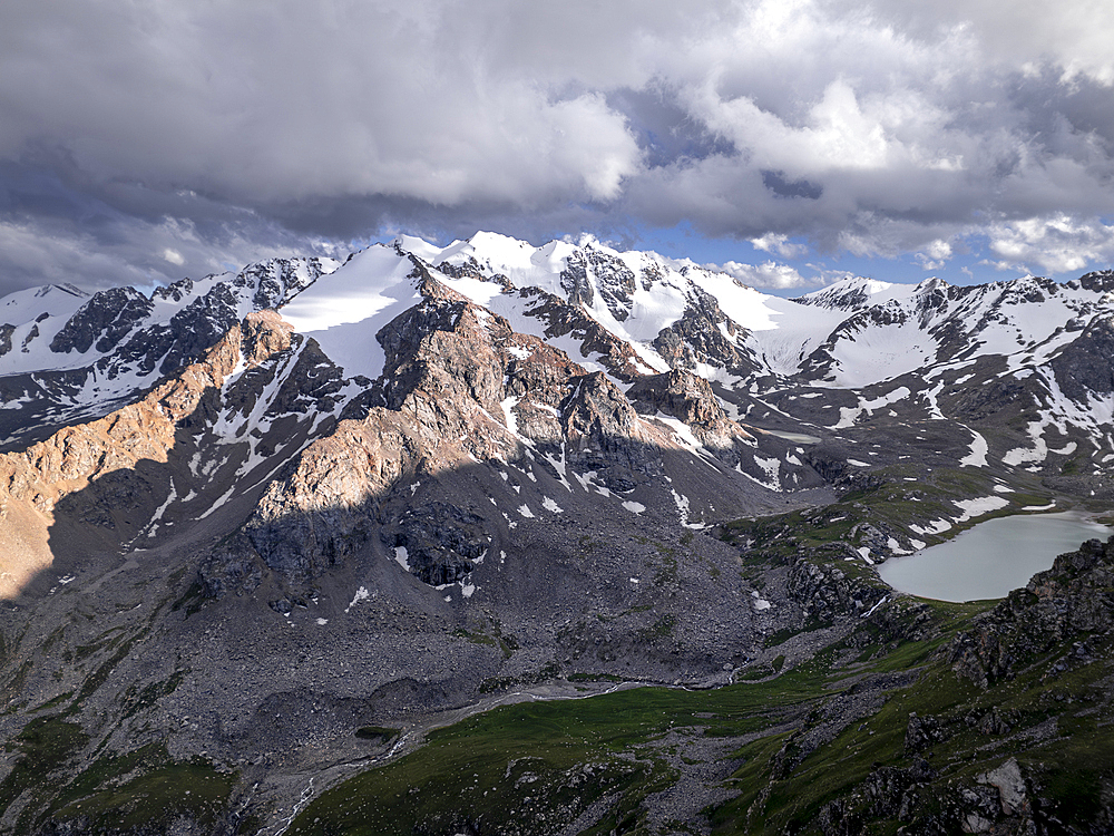 Snow-capped peaks and lush valleys at sunset showcased in a stunning landscape, Kyrgyzstan, Central Asia, Asia