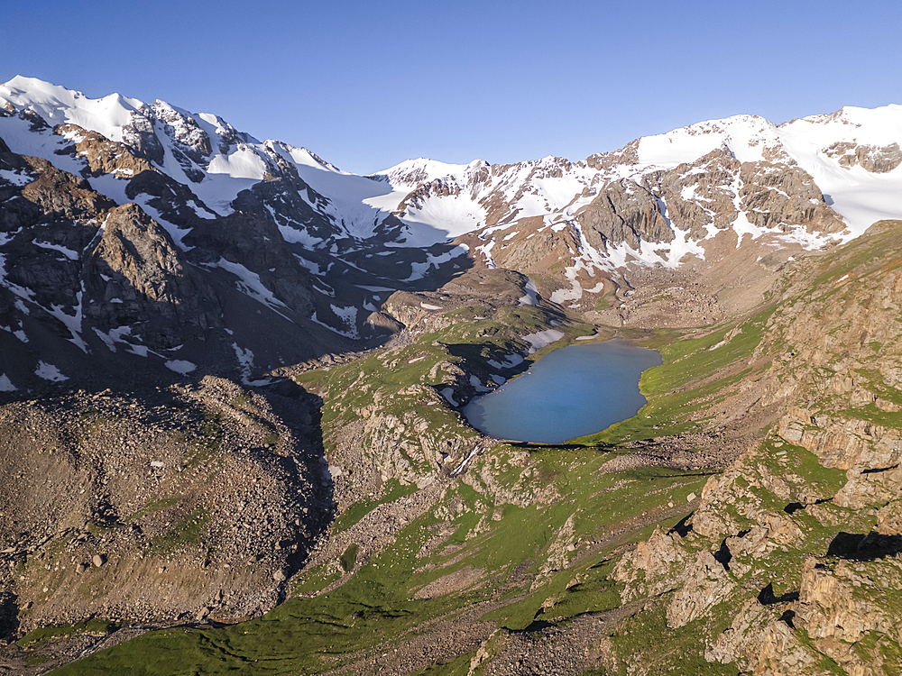 Snow-capped peaks and Kol Tor Lake in a lush valley showcasing stunning landscape, Kyrgyzstan, Central Asia, Asia