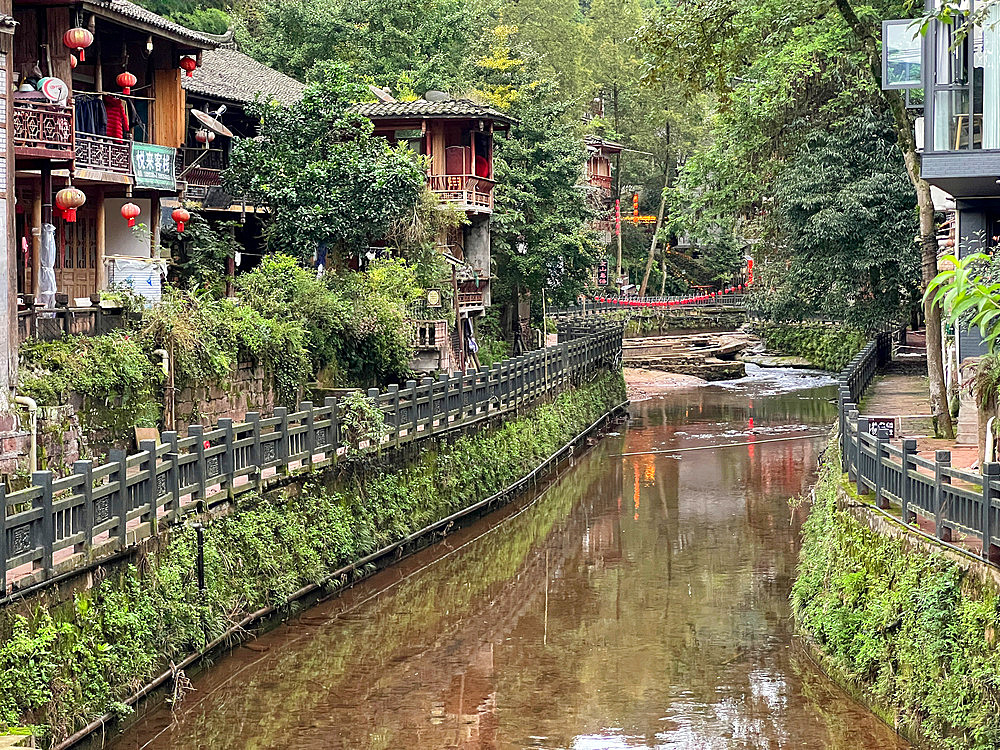 The river passing by wooden houses in Shangli Town