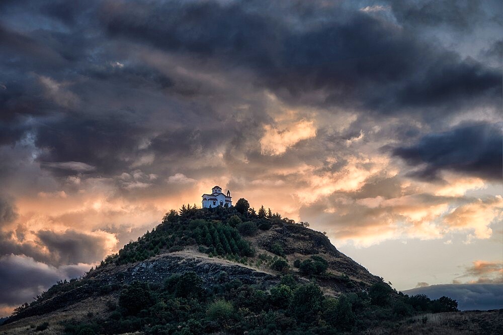 Cloudy sunset on a small church on the top of a hill, Thessaly, Greece, Europe