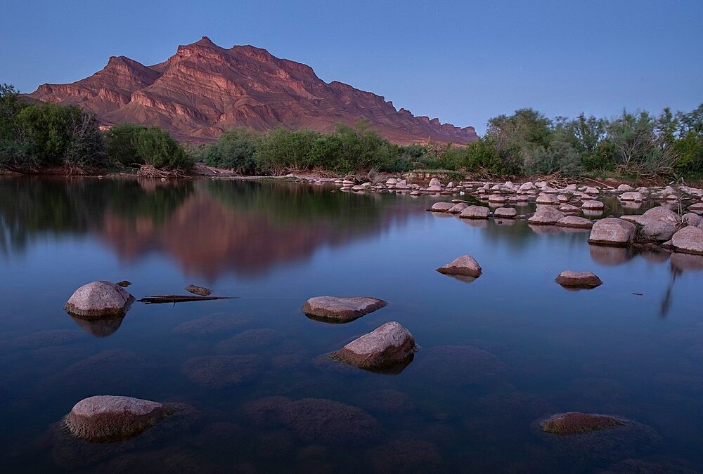 Blue hour in an oasis in the Draa Valley with a calm pond and a mountain in the background, Draa Valley, Morocco, North Africa, Africa