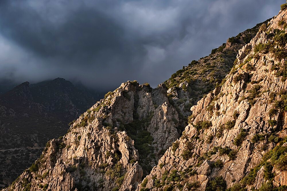 Sunset light on a rocky mountain and dark clouds in the sky, Chefchaouen, Morocco, North Africa, Africa