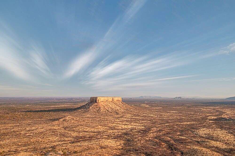 Desert landscape of Damaraland with a lonely rock in the middle, Namibia, Africa