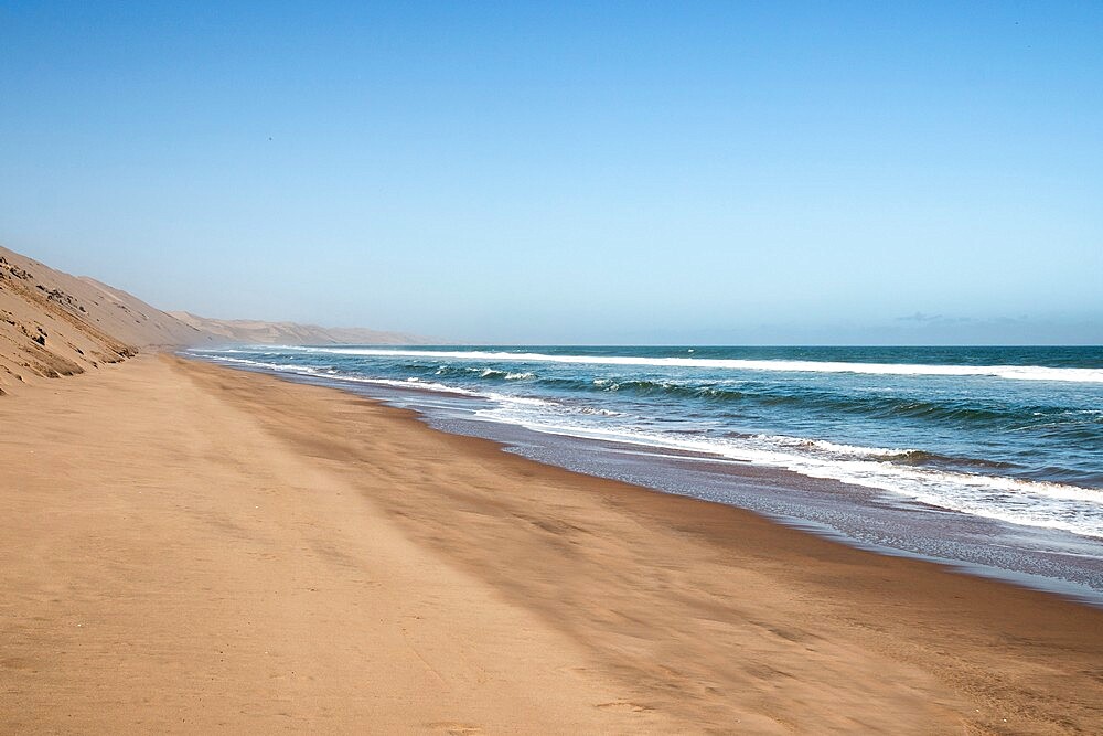 High sand dunes of the Namib Desert meet the ocean, Sandwich Harbour, Namibia, Africa