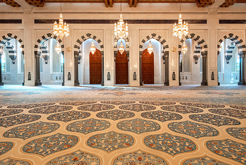 Male praying room of the Sultan Qaboos Mosque with decorated carpet and many arches, Muscat, Oman, Middle East