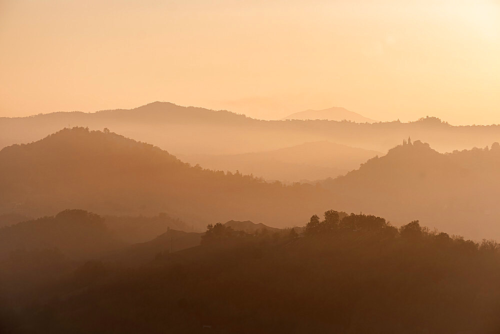 Sunset light reflected in the mist on countryside hills, Emilia Romagna, Italy, Europe