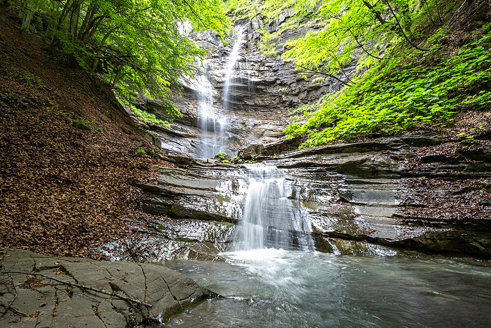 Lavachiello Waterfall flows in the woods in summertime, Emilia Romagna, Italy, Europe