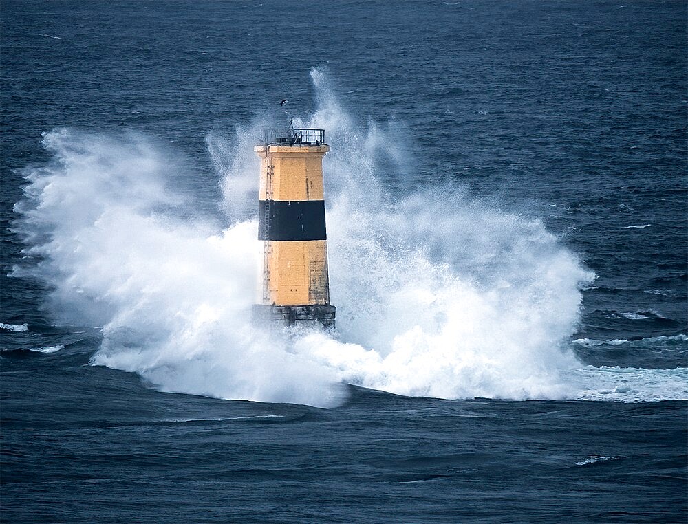 Waves crash on Tourelle de la Plate Lighthouse, Pointe du Raz, Finistere, Brittany, France, Europe