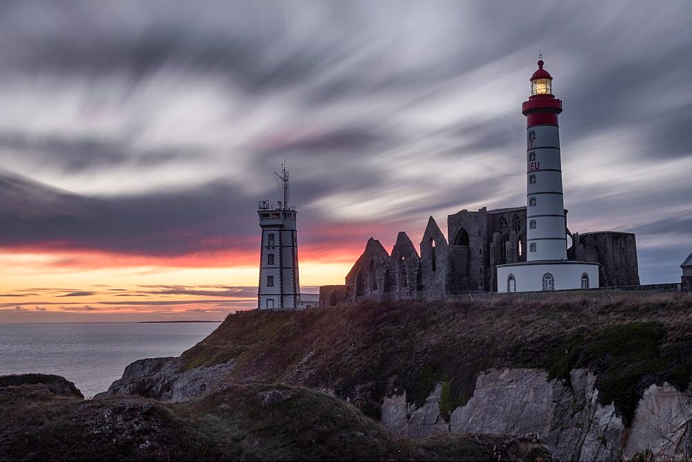 Sunset long esposure at Saint Mathieu lighthouse with some ancient ruins below in Brittany, France