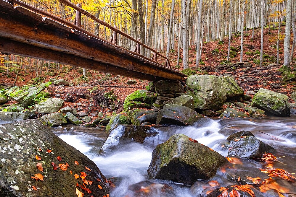 Long exposure waterfalls and a wooden bridge in autumn, Parco Regionale del Corno alle Scale, Emilia Romagna, Italy, Europe