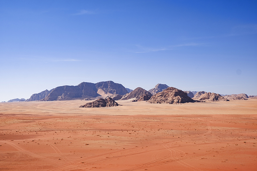 Red sand and mountains under a blue sky in the Wadi Rum desert, Jordan, Middle East