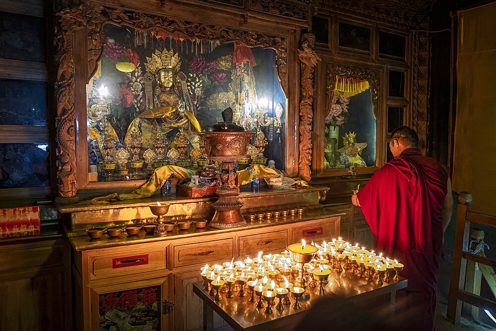 A Buddhist monk praying in the Bati temple, Gansu, China, Asia