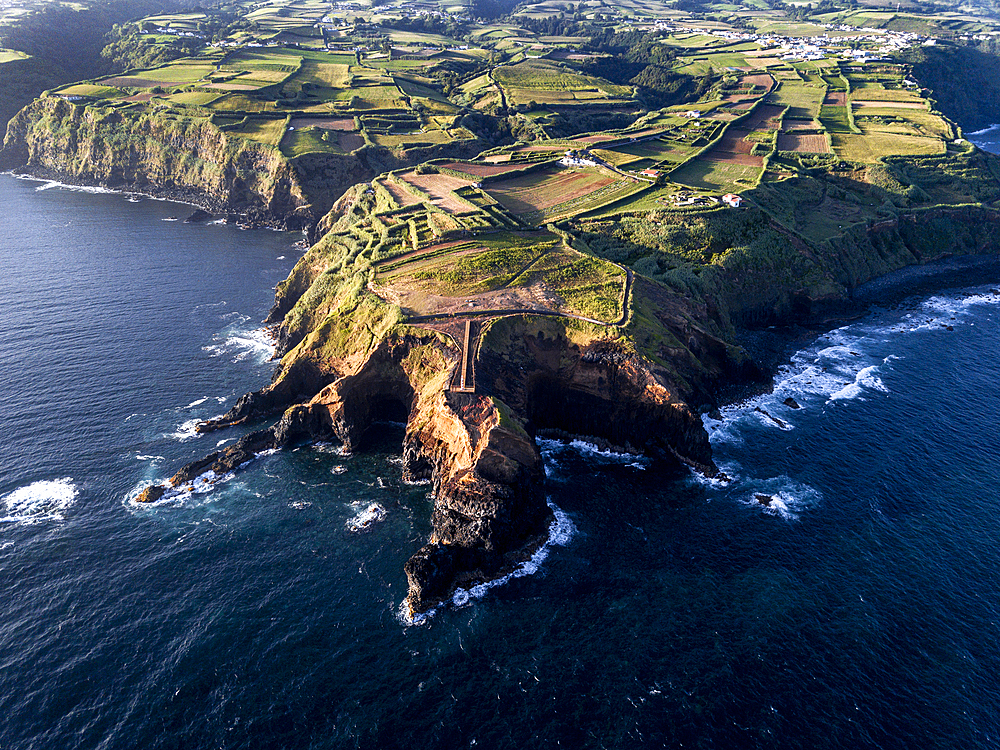 Aerial view of the coasts and cliffs of the island of Sao Miguel over the lighthouse of Farolim dos Fenais da Ajuda, Azores Islands, Portugal, Atlantic, Europe